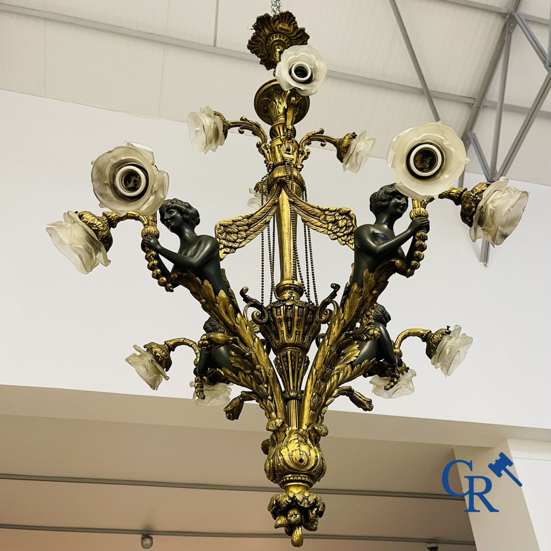 Chandelier: A large bronze chandelier in empire style. Period 1920.