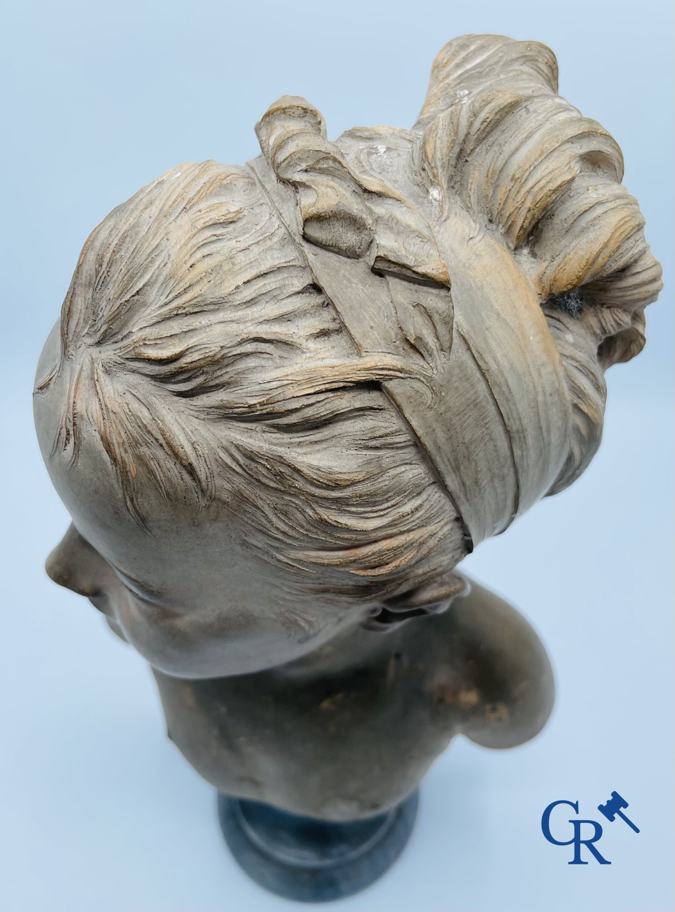 A bust in terre cuite on a blue gray marble pedestal. 19th century. - Image 5 of 8