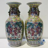 Asian art: A pair of Chinese famille rose vases with yellow background with court scenes. 19th centu