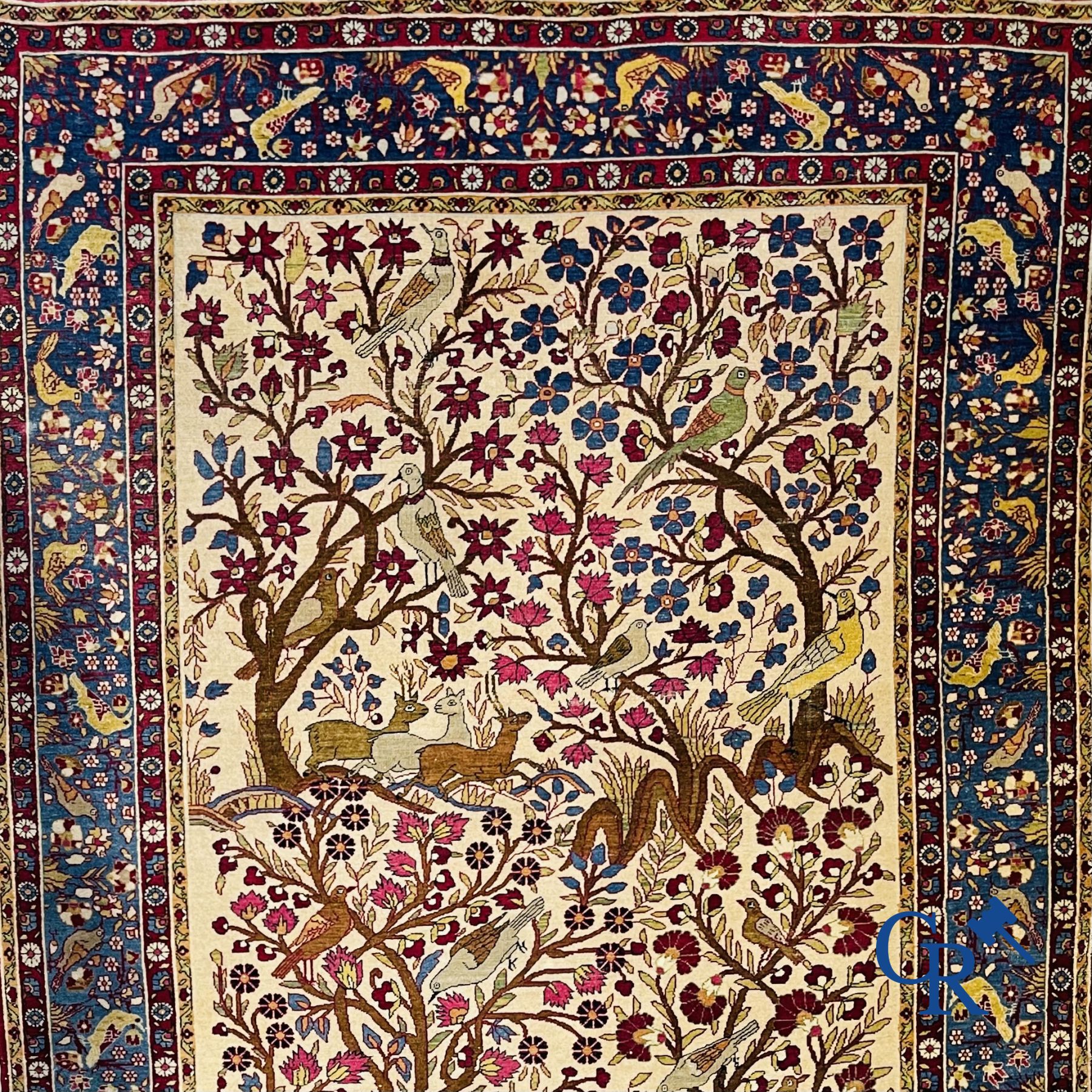 Oriental carpets: Antique oriental carpet with a decor of animals and birds in the forest.