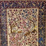 Oriental carpets: Antique oriental carpet with a decor of animals and birds in the forest.