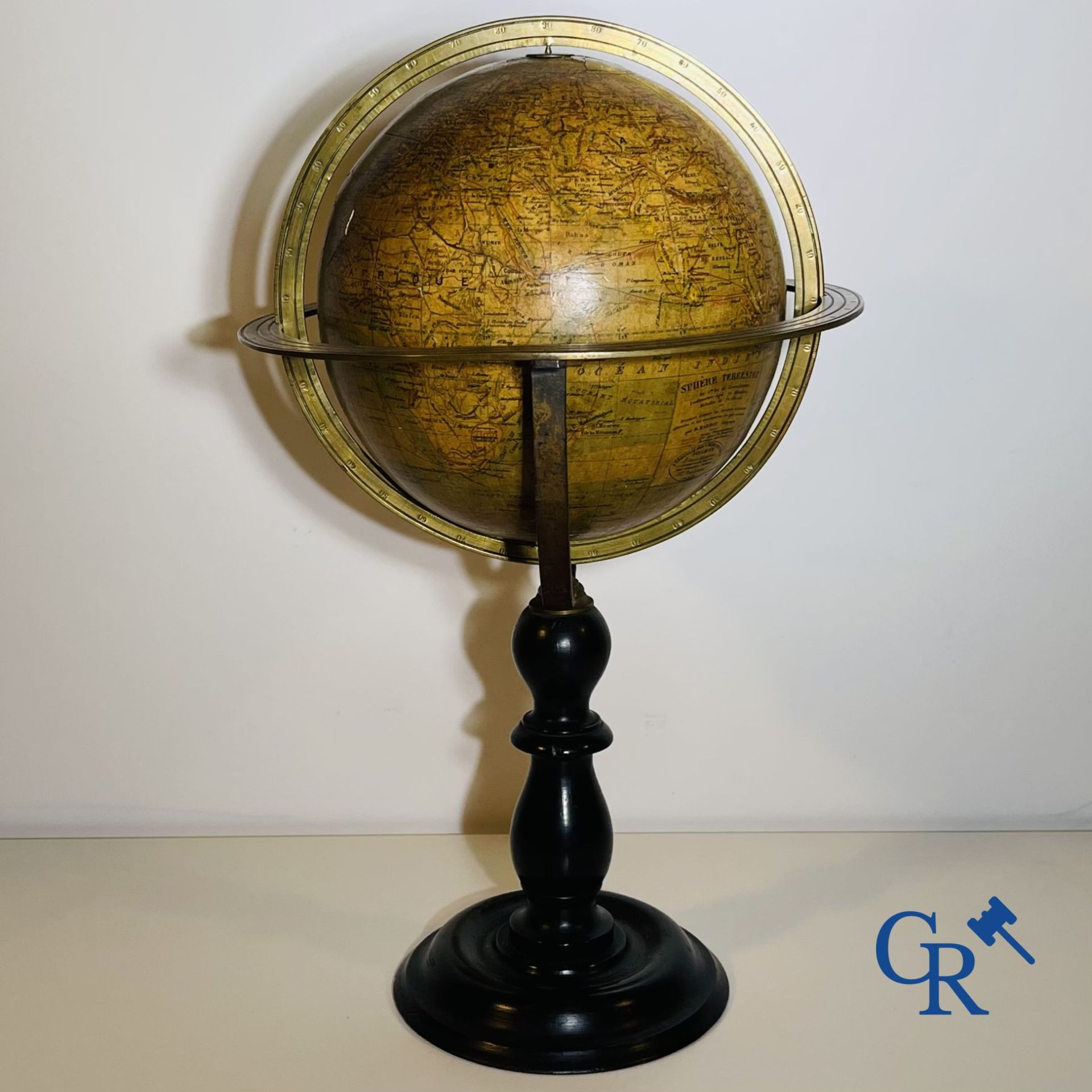 An antique globe with meridian circle on a black lacquered wooden base. 19th century.