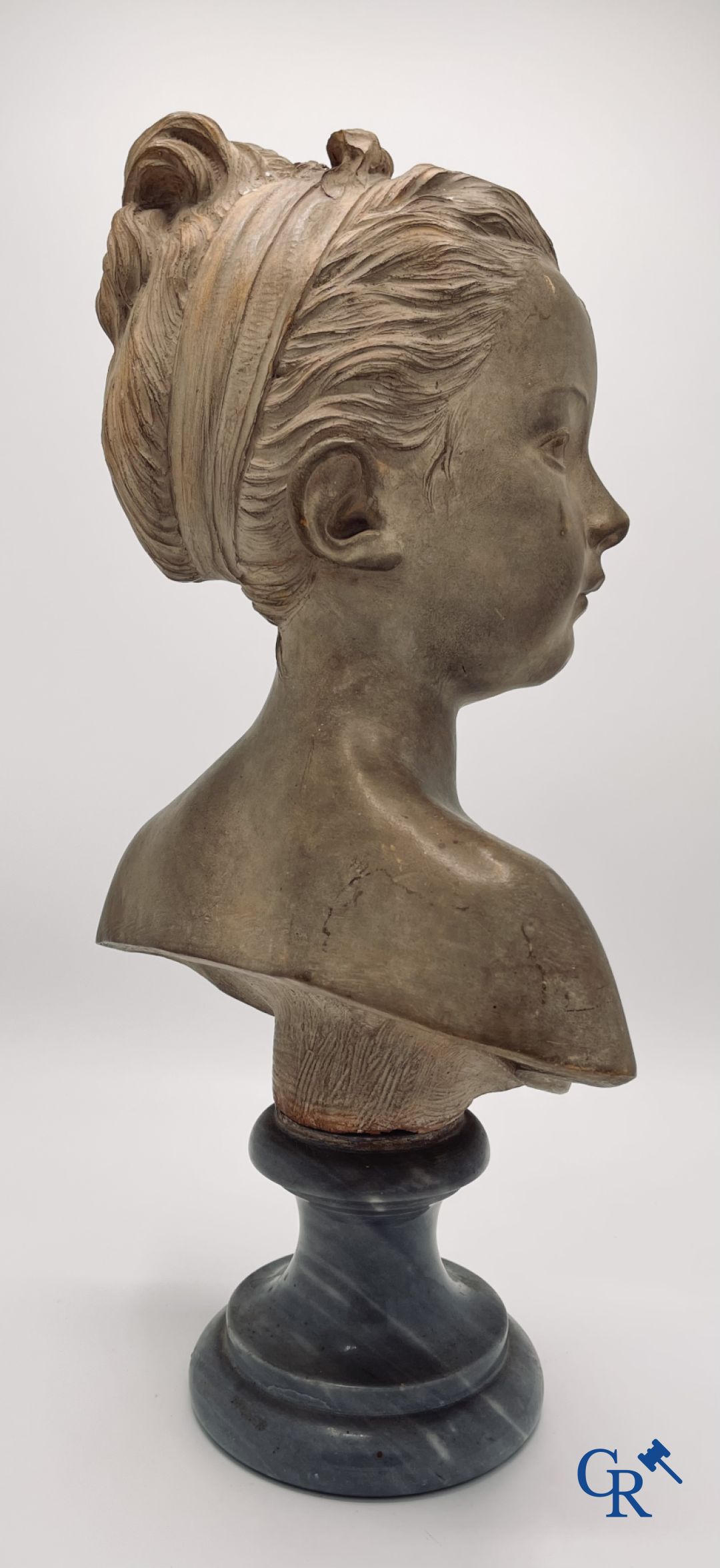 A bust in terre cuite on a blue gray marble pedestal. 19th century. - Image 3 of 8