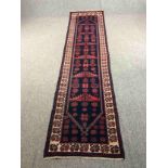 Runner, Eastern stylised floral motifs on a midnight ground. L.300 W.76cm.