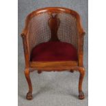 A mid century walnut George I style tub chair with bergere caned back and sides. H.88 W.56cm.