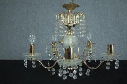 A brass chandelier with four branches of lights and decorated with hanging beaded glass. H.33 Dia.