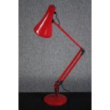 An Anglepoise lamp in red. Probably made in the 80s. H.83 cm.