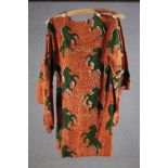 A vintage bespoke made long top with orange and black abstract design and green rearing horses.