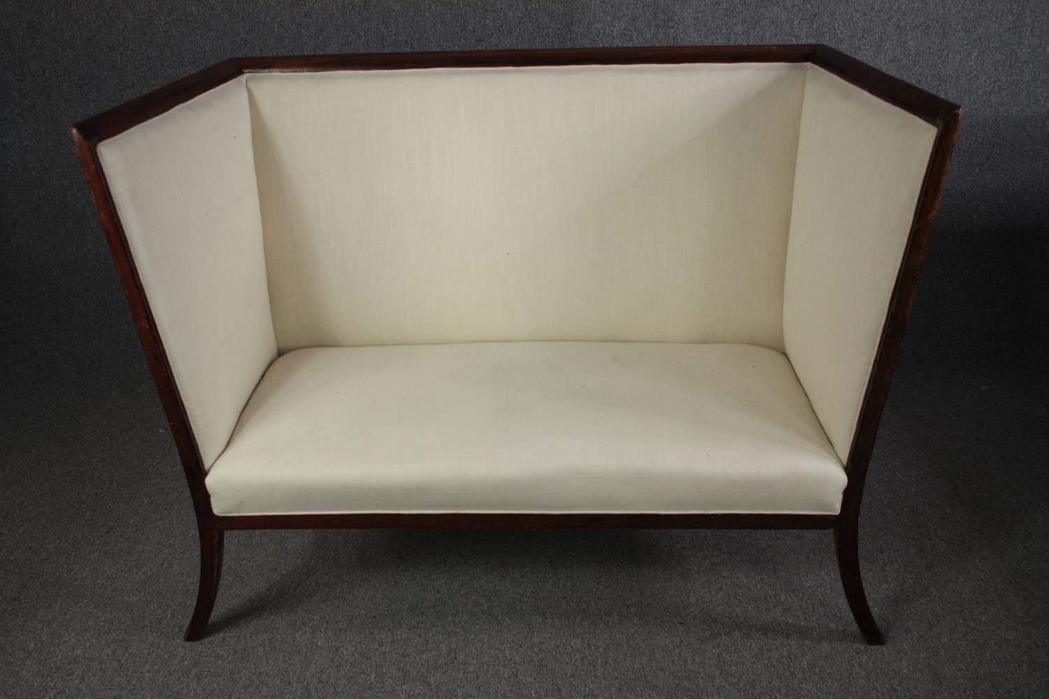 An Edwardian mahogany framed high back canape reupholstered in ivory fabric. H.106 W.137 D.62cm.