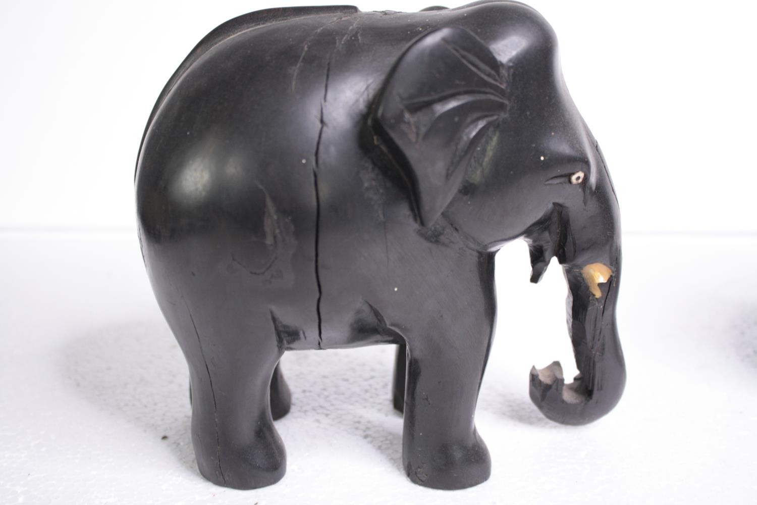 Two carved ebony elephants. Missing their tusks. Early to mid twentieth century. H.15 W.18cm. ( - Image 3 of 6