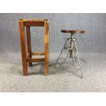 A contemporary industrial style metal framed stool along with a distressed painted teak stool. H.