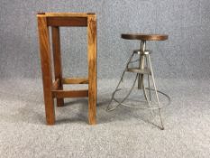 A contemporary industrial style metal framed stool along with a distressed painted teak stool. H.