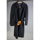 A bespoke made vintage navy blue woollen overcoat with statement buckle.