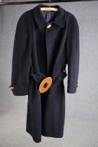 A bespoke made vintage navy blue woollen overcoat with statement buckle.