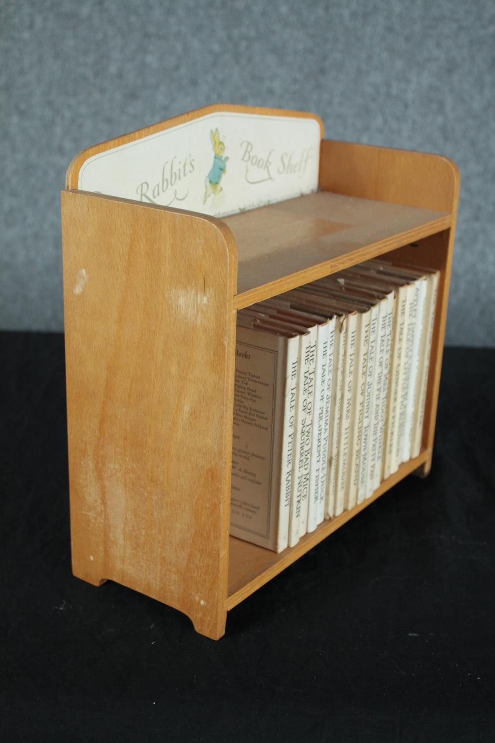 A collection of late editions of Beatrix Potter books housed in a bookshelf. H.28 W.28 D.12cm. - Image 3 of 4