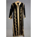 A vintage bespoke made black velvet long coat with gold brocade and thread embellishment.