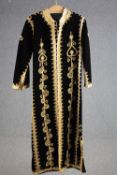 A vintage bespoke made black velvet long coat with gold brocade and thread embellishment.