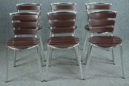A set of six metal and faux wood slatted chairs.