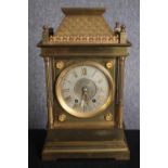 A 19th century brass architectural design mantle clock with tile detailing to the roof. Silvered