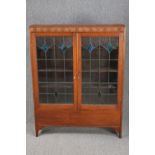 Bookcase, mid century oak with leaded and coloured glass doors. H.137 W.107 D.24cm.