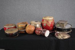 A collection of ethnic drums. Including thumb piano, and early twentieth century Chinese drums
