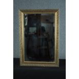 A contemporary gilt framed wall mirror with bevelled plate. H.76 W.53cm.