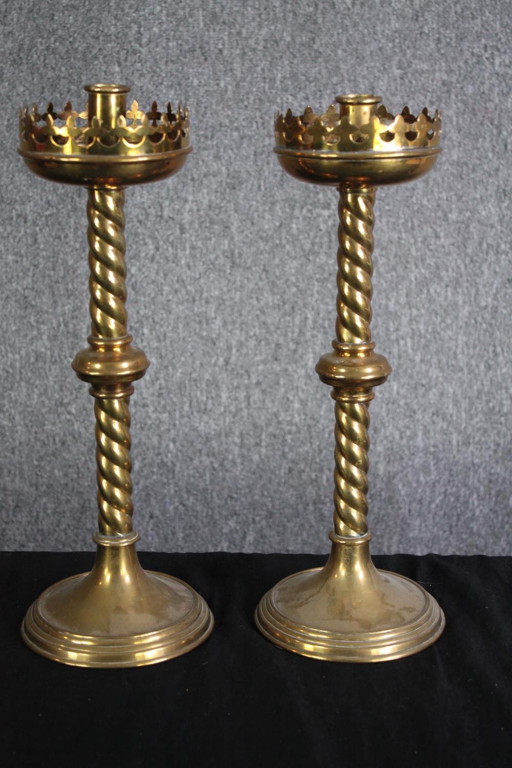 A pair of Gothic style brass candle holders with twist stems. H.40cm. (each)