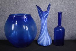 A collection of three blue glass vases. Studio glass. The vase with white striking is marked 'Amy