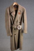 A vintage bespoke made tweed long length overcoat with statement buckle.