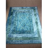 An Indian cotton bedspread embroidered in shades of blue and teal. L.265 W.210 cm.
