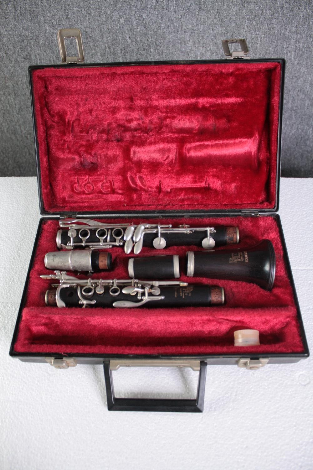 A Boosey and Hawkes clarinet. Complete and in its original felt lined case. L.35 W.23 cm.