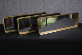 A set of three contemporary gilt metal framed mirrors. H.21 W.61cm. (each)