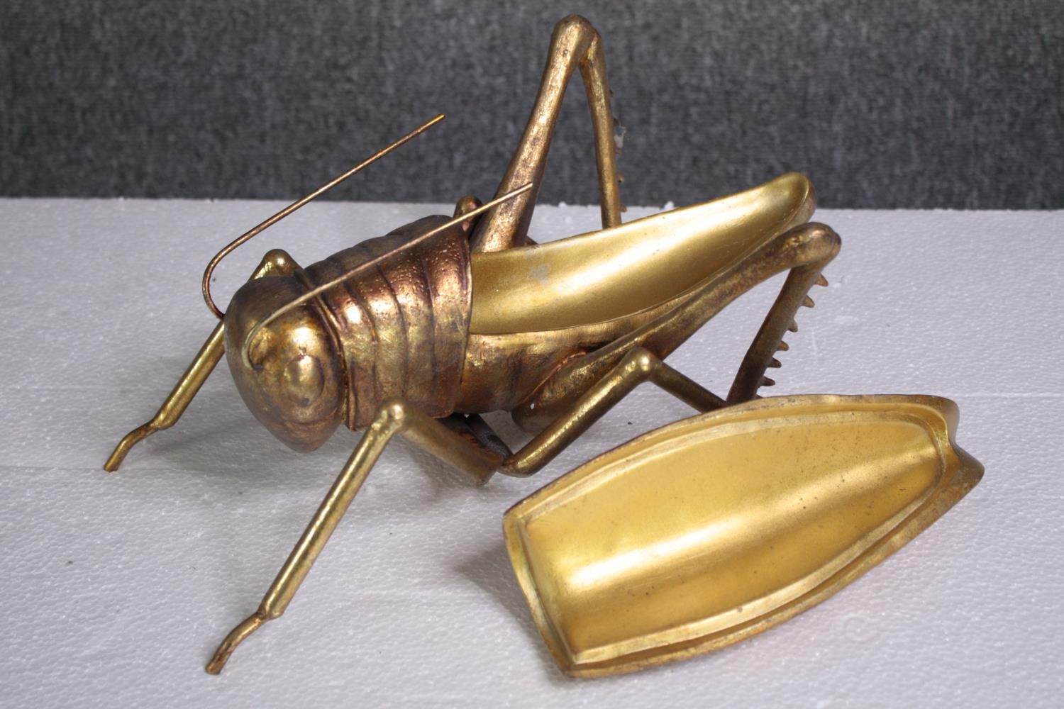 A decorative grasshopper, gold lacquered. H.5 W.39cm. - Image 3 of 5