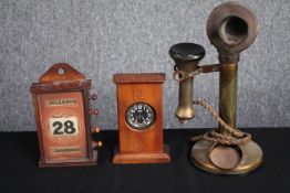 An old brass telephone, a hand wound paper calendar and, a wooden cased pocket watch. H.30cm. (