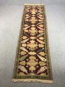 A Shirvan runner with repeating palmette and serrated palm motifs on a claret ground within