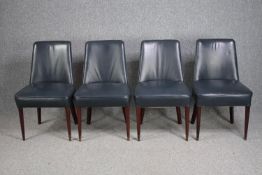 Dining chairs, mid century leather upholstered with brass capped feet.