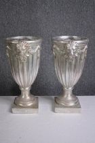 A pair of matching urns decorated with lions heads. H.43cm.(each)