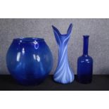 A collection of three blue glass vases. Studio glass. The vase with white striking is marked 'Amy