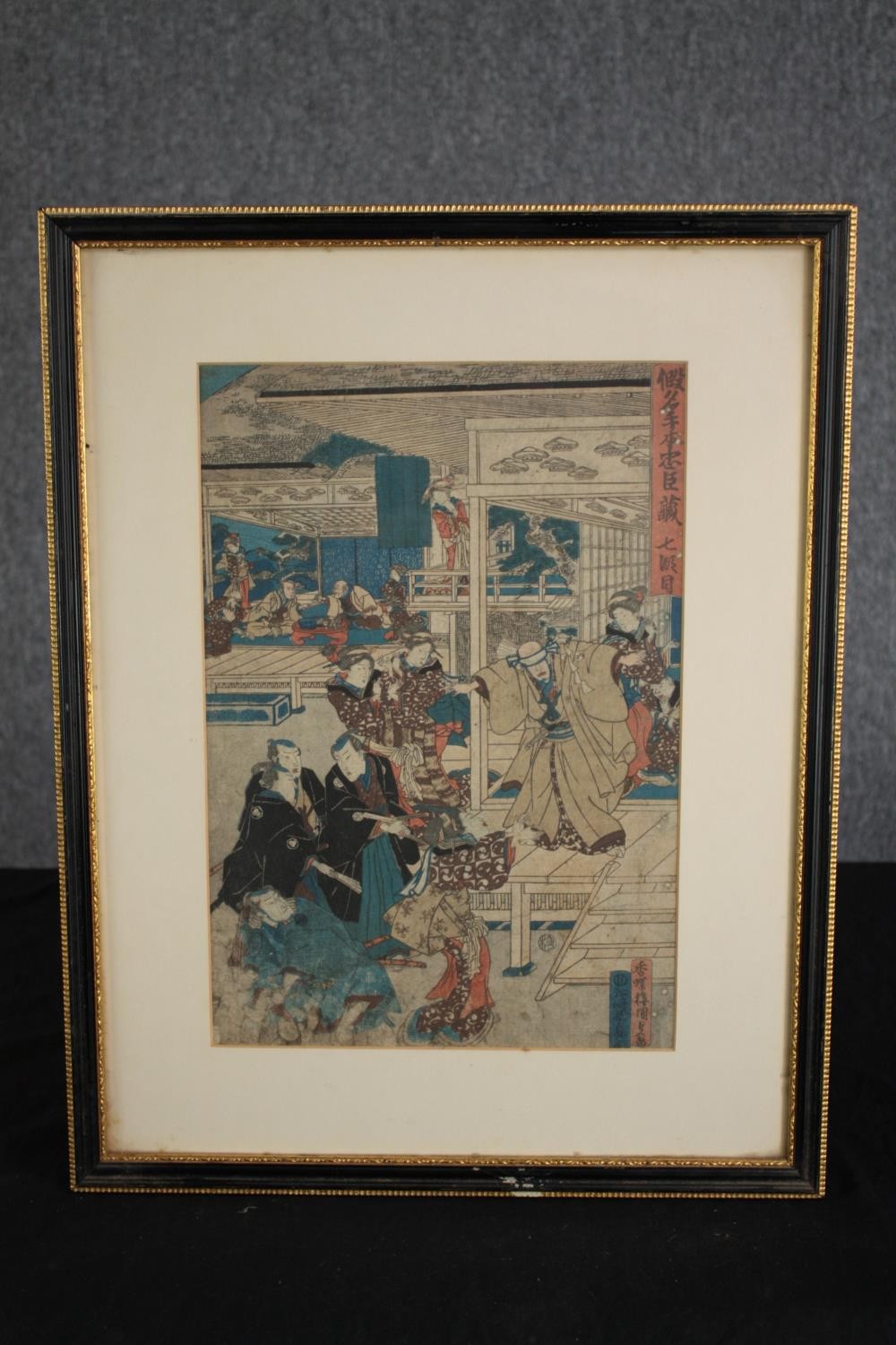 A Japanese hand coloured woodcut. A dramatic scene showing a samurai worrier in the act of - Image 2 of 3