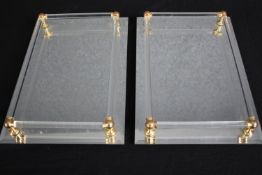 A pair of mirrored glass trays. H.37 W.25cm.(each)
