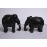 Two carved ebony elephants. Missing their tusks. Early to mid twentieth century. H.15 W.18cm. (