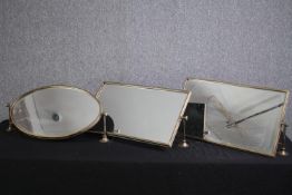 A collection of three wall mounted adjustable mirrors. H.35 W.60cm. (largest)