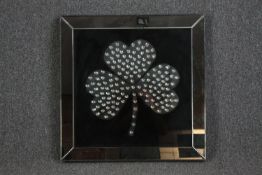 A mirror with shamrock decoration. H.70 W.70cm.