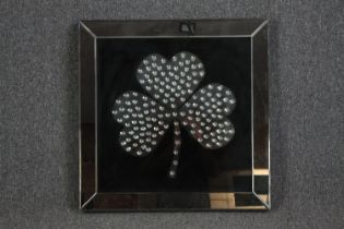 A mirror with shamrock decoration. H.70 W.70cm.