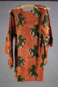 A vintage bespoke made long top with orange and black abstract design and green rearing horses, (