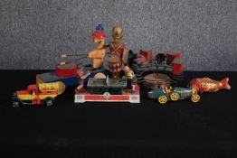 A collection of retro tin wind up toys including a musical train. A couple in need of restoration.