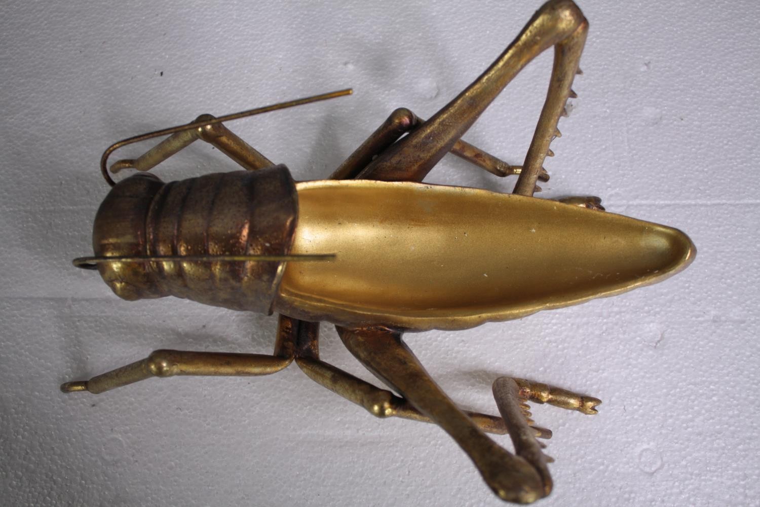 A decorative grasshopper, gold lacquered. H.5 W.39cm. - Image 4 of 5