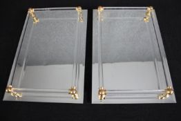 A pair of mirrored glass trays. H.37 W.25cm.(each)