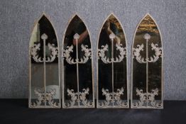 A set of four metal framed arched mirrors with applied foliate decoration. H.62 W.20cm.(each)