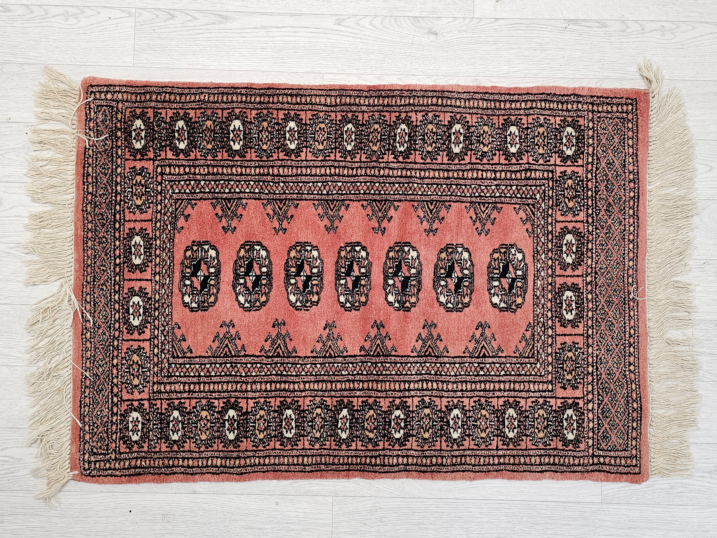 A Bokhara style rug. H.109 W.65cm.